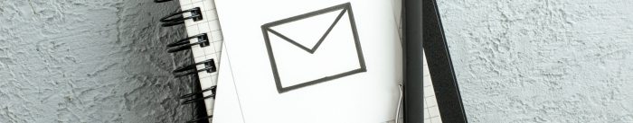 top-view-message-drawing-white-sheet-pen-spiral-notebook-book-gray-sand-background